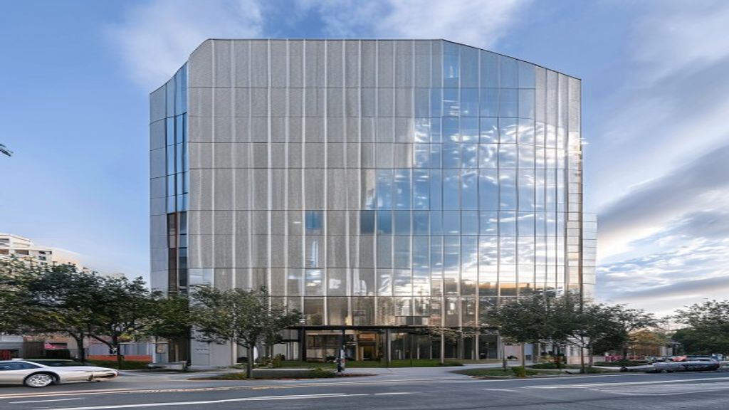 Mid-rise corporate office building clad in champagne metalite aluminium composite panels, clean geometric horizontal lines, shadow gaps between cassettes, urban street-level perspective, overcast daylight, detailed facade texture